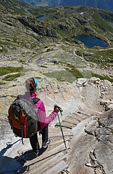 Woman hiking in the mountains on a tourist track