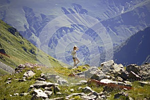 Woman hiking in mountains. Travelling background. Summer time. Vacation time
