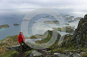 Woman hiking near Henningsvaer on a rainy day