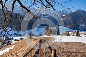 Woman on hiking path in winter starting from Zell Pfarre towards Freiberg, Austrian Alps, Carinthia (Kaernten), Austria