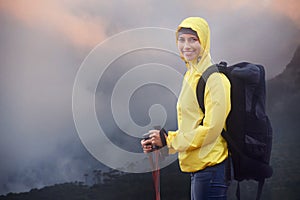 Woman, hiking and portrait with trekking sticks, winter and support for fog trail in mountain. Athlete, backpack and