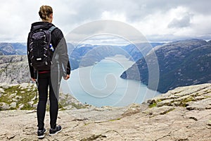 Woman hiking at the pulpit rock in lysefjorden Norway