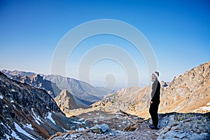 Woman hiking in the Slovak Tatra Mountains in autumn. Beautiful mountain view of the Slovak part of the Tatra
