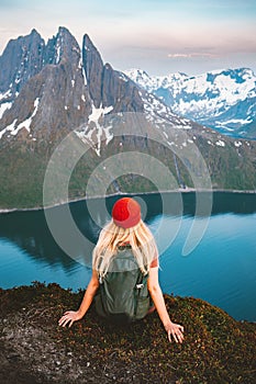 Woman hiking solo traveling in Norway female tourist with backpack enjoying view in mountains outdoor healthy lifestyle