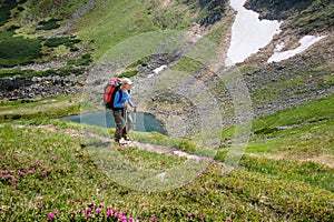 Woman hiking with sticks in Carpathian mountains