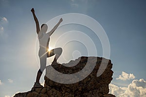 Woman hiking success silhouette in mountain sunset