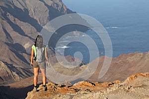 Woman hiking on top volcanic craters on St Helena photo