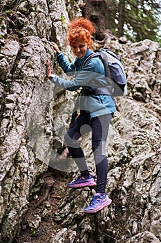 Woman hiking on a trail in the mountains