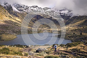 Woman hiking the tranquil trails at Tristaina Lakes, Andorra