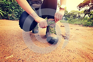 Woman hiking tying shoelace