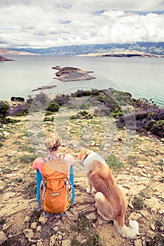 Woman hiking walking with dog on seaside trail