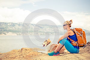 Woman hiking walking with dog on seaside trail