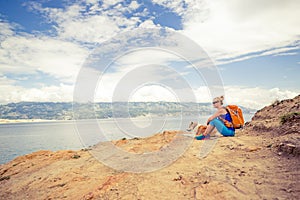 Woman hiking walking with dog on seaside trail