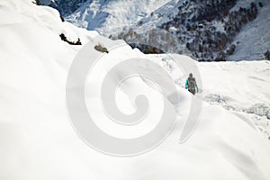 Woman hiking in white winter mountains