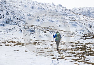 Woman hikking in the Julian Alps. Frozen landscape.