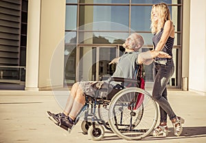 Woman and his boyfriend on the wheelchair going out
