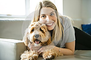 Woman with his Golden Labradoodle dog at home