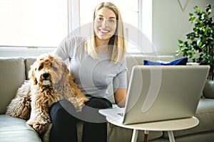 Woman with his Golden Labradoodle dog at home