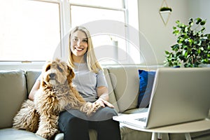 Woman with his Golden Labradoodle dog at home