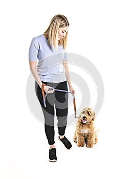 Woman with his Golden Labradoodle dog isolated on white background