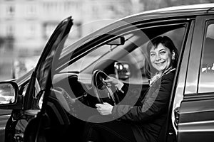 A woman in his new car. Black and white photo.