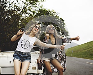 Woman Hitch Hiking on The Street Side Near The Broke Down Car