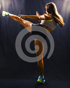 Woman hitting with a high kick