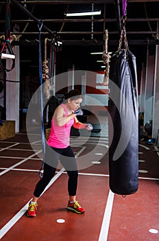 Woman hitting the punching bag