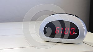 Woman Hitting Snooze on Alarm Clock