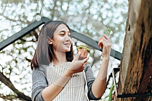 Woman hold cactus and a man writing note in a book. Love couple enjoy hobby with garden cactus