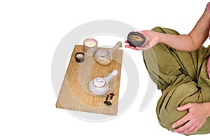 Woman hold a Chinese tea ceremony with a teapot, isolated on a white background