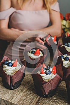 Woman hold chocolate cake in hand.