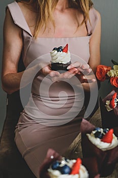 Woman hold chocolate cake in hand.