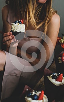 Woman hold chocolate cake in hand.