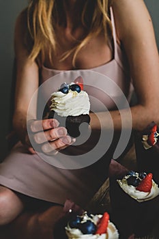 Woman hold chocolate cake in hand.