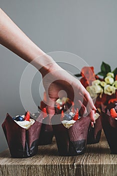 Woman hold chocolate cake in her hand.