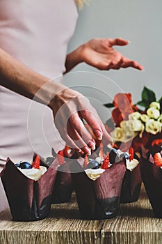 Woman hold chocolate cake in her hand.