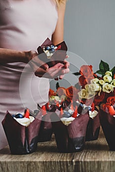 Woman hold chocolate cake in her hand.