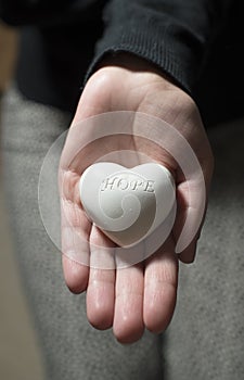 Woman hold in hands heart. Text hope