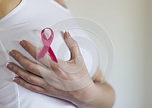 Woman hold her breast and have sign for breast cancer on it