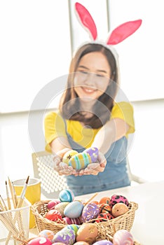 Woman hold homemade colorful painted easter egg