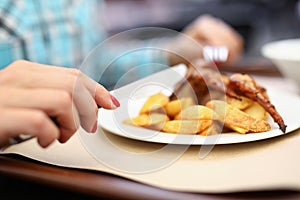 Woman hold knife and fork in her hand.