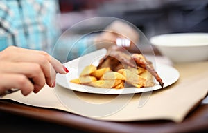 Woman hold knife and fork in her hand.