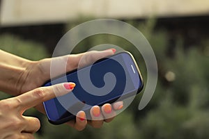 Woman hold mobile phone and point hers finger photo