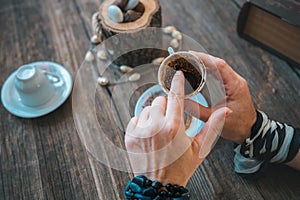 Woman hold the mug and telling fortune with traditional turkish coffee cup.