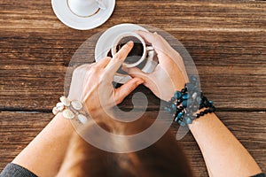 Woman hold the mug and telling fortune with traditional turkish coffee cup.
