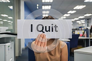 Woman hold paper of I quit in office