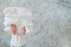 Woman hold pile white pillows bedding sleeping