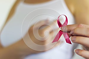 Woman hold pink ribbon for breast cancer awareness photo