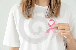 Woman hold pink ribbon breast cancer awareness. Female health check consciousness. international Women Day and World Cancer Day.